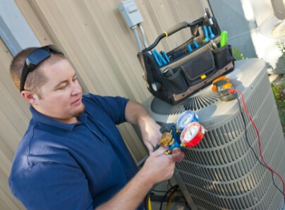 A techicain working on an Air Conditioning unit.