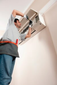 technician-performing-ductless-AC-maintenance